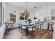 Bright dining room boasts chandelier lighting, hardwood floors, and kitchen access at 2816 Breton Woods, Sarasota, FL 34235