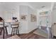 Open foyer with decorative light fixture, wood flooring, and open view of kitchen at 2816 Breton Woods, Sarasota, FL 34235