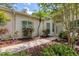Inviting front entrance with mature landscaping and walkway at 2816 Breton Woods, Sarasota, FL 34235