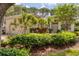 Inviting single-story home with lush landscaping, a well-maintained lawn, and a tile roof at 2816 Breton Woods, Sarasota, FL 34235