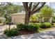 Charming home featuring a tile roof, neutral exterior paint, mature landscaping, and a spacious driveway at 2816 Breton Woods, Sarasota, FL 34235