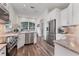 Spacious kitchen features stainless steel appliances, granite counters, and ample cabinet space at 2816 Breton Woods, Sarasota, FL 34235