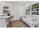 Bright kitchen with breakfast bar seating and a comfortable white sofa at 2816 Breton Woods, Sarasota, FL 34235