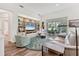 Open-concept living room featuring built-in shelving and sliding glass doors at 2816 Breton Woods, Sarasota, FL 34235