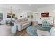 Open living space offers hardwood floors, comfortable seating, and views to the kitchen at 2816 Breton Woods, Sarasota, FL 34235