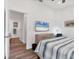 Bright main bedroom with ensuite bathroom, TV, and natural wood flooring at 2816 Breton Woods, Sarasota, FL 34235
