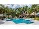 Community pool with ample seating and lush landscaping at 2816 Breton Woods, Sarasota, FL 34235