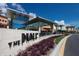 Shopping mall entrance with a stylish sign, modern architecture and a variety of stores at 2816 Breton Woods, Sarasota, FL 34235