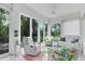Cozy sunroom with tile floors, large windows, and comfortable seating at 2816 Breton Woods, Sarasota, FL 34235