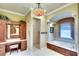 Bathroom featuring wooden cabinets, double sinks, a walk-in shower and a soaking tub at 2901 Little Country Rd, Parrish, FL 34219