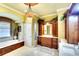 Spa-like bathroom featuring a soaking tub, a custom vanity, and elegant lighting at 2901 Little Country Rd, Parrish, FL 34219
