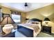 Cozy bedroom with a dark wood bed frame, side tables, and soft lighting at 2901 Little Country Rd, Parrish, FL 34219