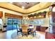 Formal dining room with large windows, a decorative ceiling and views of the pool at 2901 Little Country Rd, Parrish, FL 34219