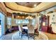 Elegant dining room with a decorative ceiling, beautiful chandelier, and great natural light at 2901 Little Country Rd, Parrish, FL 34219