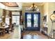 Elegant foyer featuring a chandelier, decorative tile flooring, and a view into the adjacent dining room at 2901 Little Country Rd, Parrish, FL 34219