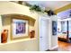 Stylish hallway with art niche, decorative plants, and a view into the bedroom at 2901 Little Country Rd, Parrish, FL 34219