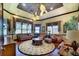 Inviting living room with patterned ceiling, rich wood floors, and comfortable seating at 2901 Little Country Rd, Parrish, FL 34219
