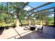 Spacious screened lanai with brick pavers and seating area, overlooking the golf course at 2901 Little Country Rd, Parrish, FL 34219