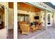 Covered patio with ceiling fan, tile flooring, and comfortable seating at 2901 Little Country Rd, Parrish, FL 34219