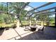 Spacious covered patio with brick pavers and outdoor seating offers a relaxing entertainment space at 2901 Little Country Rd, Parrish, FL 34219