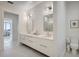 Modern bathroom featuring double sinks, marble shower, and tile flooring at 33 S Palm Ave # 1101, Sarasota, FL 34236