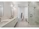 Modern bathroom featuring double sinks, marble shower, and separate tub at 33 S Palm Ave # 1101, Sarasota, FL 34236
