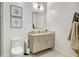Bright bathroom featuring a floating vanity, wall mirror, modern toilet, and decorative wall art at 33 S Palm Ave # 1101, Sarasota, FL 34236