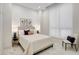 This cozy bedroom features neutral decor, a plush bed, side tables, and a bright window at 33 S Palm Ave # 1101, Sarasota, FL 34236