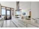Modern kitchen with sleek white cabinetry, stainless steel appliances, large island, and balcony access at 33 S Palm Ave # 1101, Sarasota, FL 34236