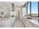 Modern kitchen featuring a large island, sleek appliances, and ample counter space with water view from window at 33 S Palm Ave # 1101, Sarasota, FL 34236