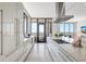 Modern kitchen with sleek white cabinetry, stainless steel appliances, and access to the balcony at 33 S Palm Ave # 1101, Sarasota, FL 34236
