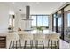 Modern kitchen featuring a large island with seating, open floorplan, and large windows with a beautiful view at 33 S Palm Ave # 1101, Sarasota, FL 34236