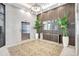 Stunning lobby area featuring a stylishly patterned floor, vertical wood paneling, and a modern chandelier at 33 S Palm Ave # 1101, Sarasota, FL 34236