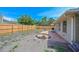 Fenced backyard featuring a small brick patio, sand box, mini trampoline, and ample space for recreation at 3417 49Th W St, Bradenton, FL 34209