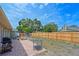 Expansive backyard with a wooden fence, brick patio, barbecue, playground, and storage shed at 3417 49Th W St, Bradenton, FL 34209