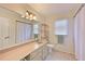 Bright bathroom featuring a shower, vanity, and tile flooring with natural light at 3417 49Th W St, Bradenton, FL 34209