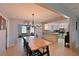 Bright dining area with a large wooden table, chandelier, and seamless flow into the kitchen at 3417 49Th W St, Bradenton, FL 34209