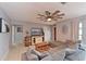 Spacious living room featuring a plush sectional sofa, decorative ceiling fan and a wall-mounted television at 3417 49Th W St, Bradenton, FL 34209