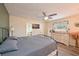 Comfortable main bedroom featuring a ceiling fan and soothing decor with a bathroom view at 3417 49Th W St, Bradenton, FL 34209