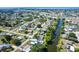 Drone shot showcasing the home's location near the canal with mature landscaping at 3585 Brooklyn Ave, Port Charlotte, FL 33952