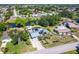 Aerial view of the house with a pond view, lush landscaping, and a private pool at 3585 Brooklyn Ave, Port Charlotte, FL 33952