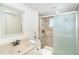 Charming bathroom featuring a vanity, mirror, and tiled shower with sliding glass door at 3585 Brooklyn Ave, Port Charlotte, FL 33952