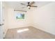 An empty bedroom with a ceiling fan and two windows at 3585 Brooklyn Ave, Port Charlotte, FL 33952