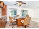 A cozy breakfast nook with granite table, wicker chairs, and lots of natural light at 3585 Brooklyn Ave, Port Charlotte, FL 33952