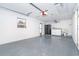 Spacious garage featuring a washer, dryer, and epoxy flooring at 3585 Brooklyn Ave, Port Charlotte, FL 33952