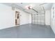 Clean garage featuring epoxy flooring and an automatic garage door at 3585 Brooklyn Ave, Port Charlotte, FL 33952