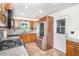 Functional kitchen featuring gas range, stainless steel refrigerator, and wooden cabinets and countertops at 3585 Brooklyn Ave, Port Charlotte, FL 33952