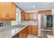 Well-equipped kitchen featuring stainless steel appliances, wooden cabinets, and granite countertops at 3585 Brooklyn Ave, Port Charlotte, FL 33952