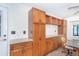 Expansive wall of wood cabinets with counters, storage options and a adjacent table and chairs at 3585 Brooklyn Ave, Port Charlotte, FL 33952