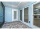Cozy lanai area featuring a screen enclosure, paver flooring, and outdoor lighting at 3585 Brooklyn Ave, Port Charlotte, FL 33952